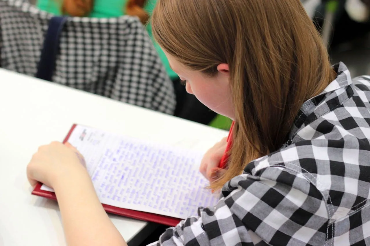 Student writing Chinese characters during a private one-on-one lesson
