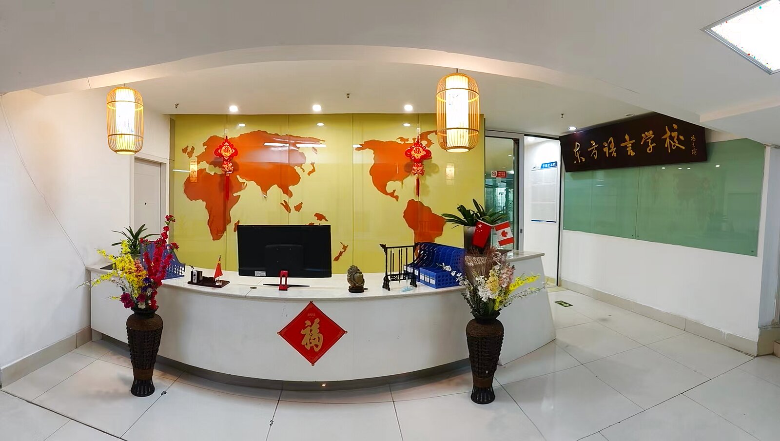Wide view of KCEL renovated reception area with bamboo lanterns and flowers