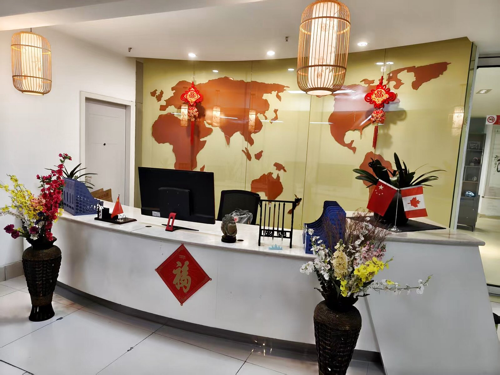 KCEL renovated front desk with world map mural and Chinese decorative knots