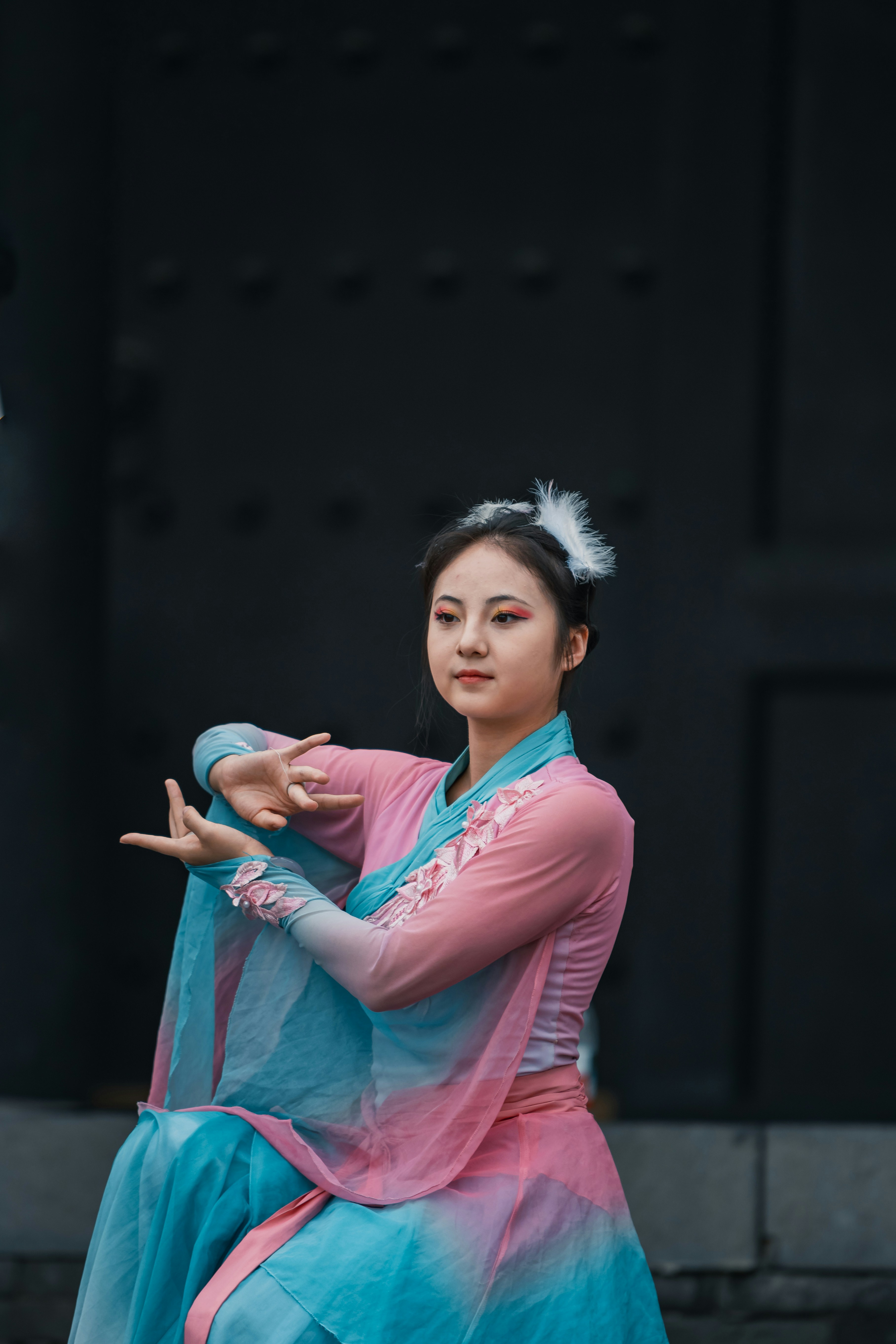 Chinese classical dancer performing in traditional hanfu costume with graceful hand gestures