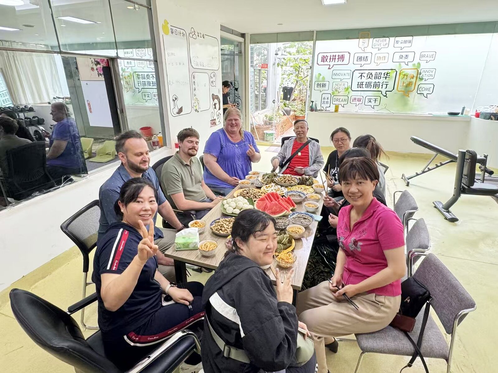 Students and teachers sharing a meal together in the KCEL gym and activity room